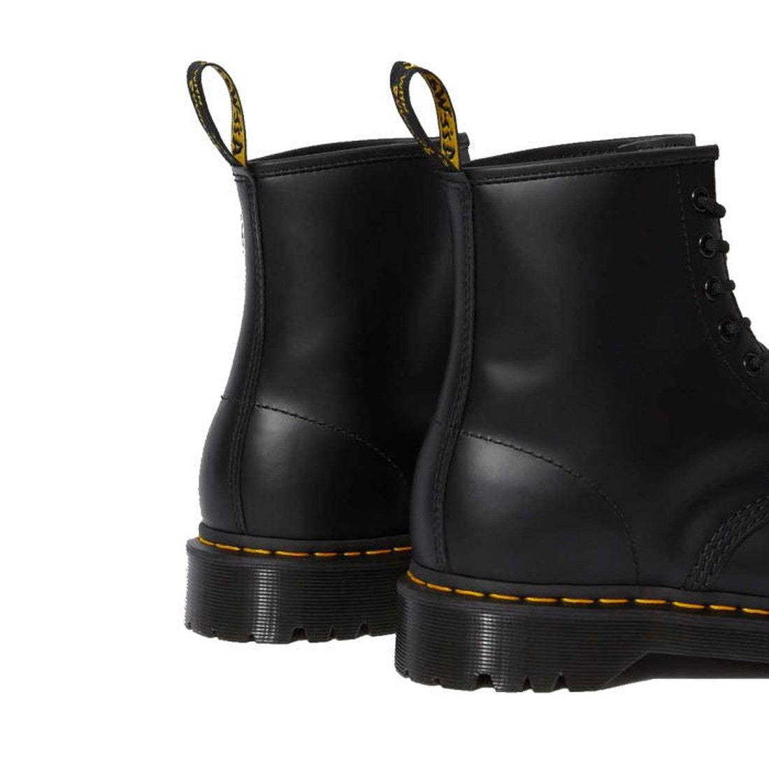 A close-up of the back of two Dr Martens - Bex 1460 8 Up Black Leather Boots features thick Bex soles, yellow stitching, and yellow heel pull tabs. The smooth leather boots are side by side, facing away from the camera., 190665298758, 190665298765, 190665