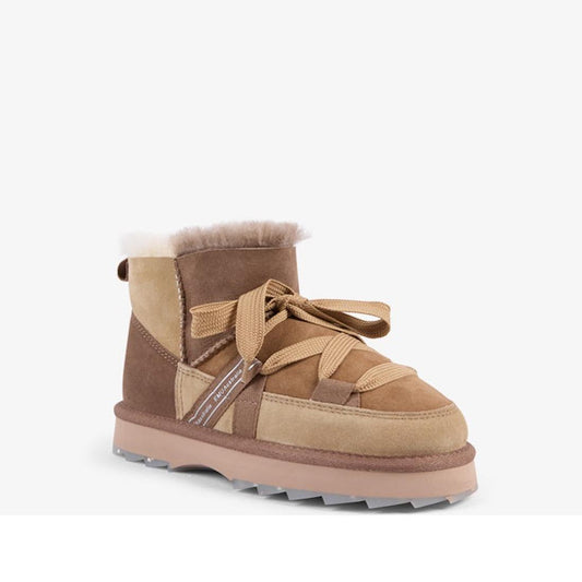The EMU Women's Blurred Micro Patchwork Sheepskin Boot in Mushroom features tan and brown suede, a thick sole, crisscross tan laces, and soft white Australian sheepskin lining, shown on a plain white background.