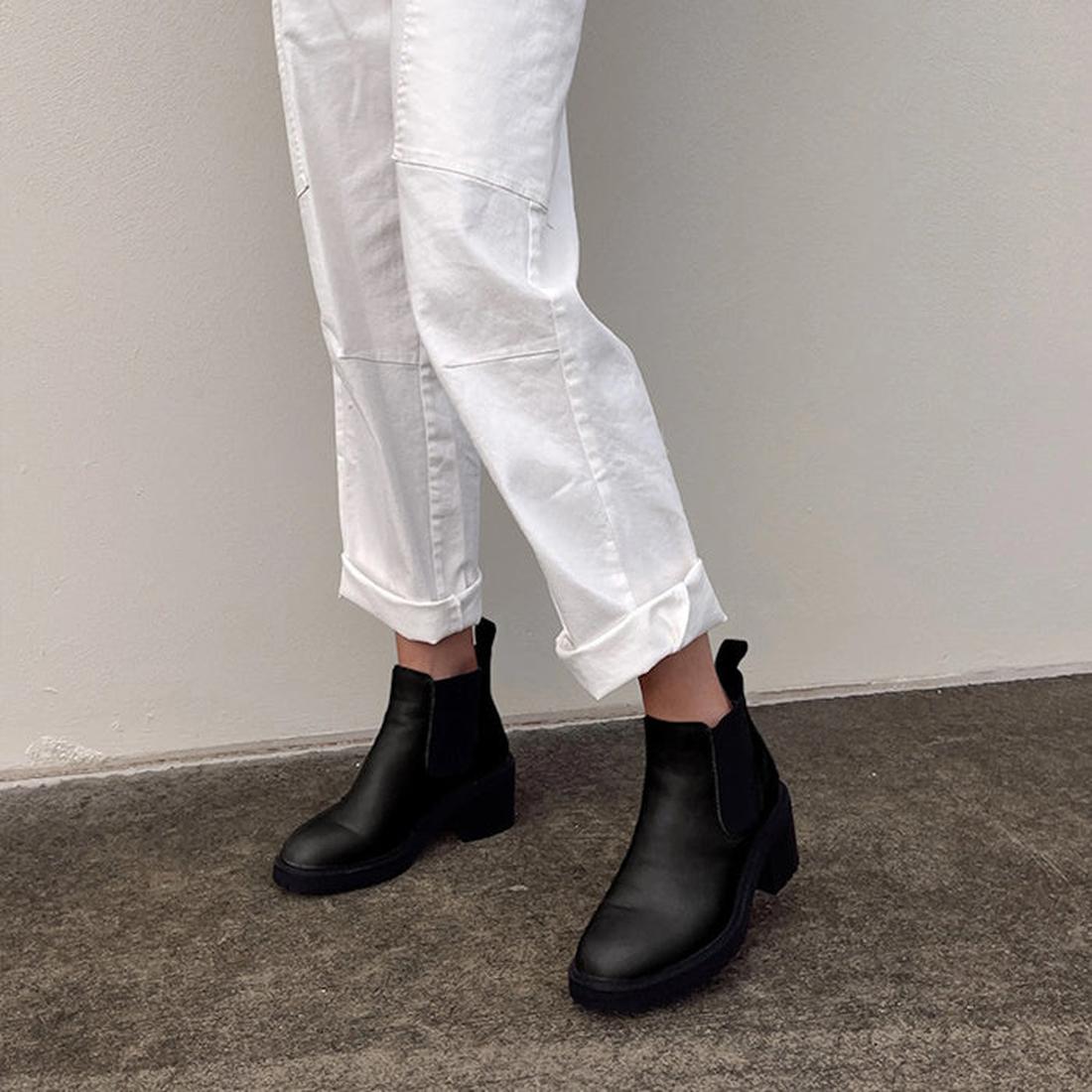 A shot of a model wearing the EMU Clara black leather chelsea  waterproof boot.,
9330071927755,
9330071927762,
9330071927779,
9330071927786,, 44280, 9330071927755, 9330071927762, 9330071927779, 9330071927786, 44285