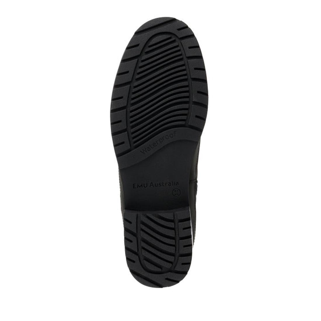 The image shows the black rubber sole of the EMU Women's Nashira Ankle Boot with deep grooves and textured tread. "Waterproof" and "EMU Australia" are embossed in the center, highlighting its durability and design., 9330071899687, 9330071899694, 933007189