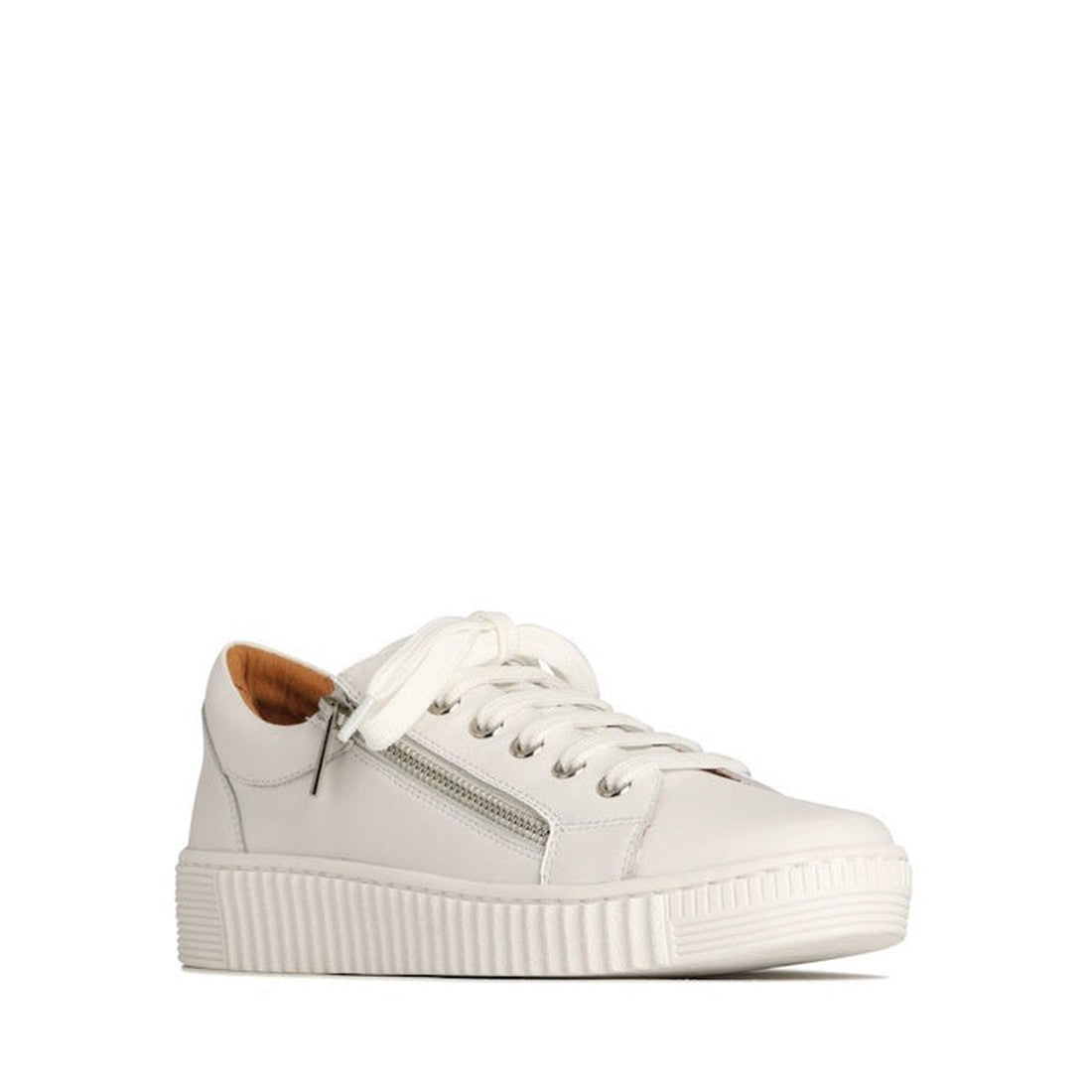 The EOS Joyce Leather Trainer is a white low-top sneaker in Italian Aniline leather featuring white laces, a side zip, and a textured sole. It has a tan heel lining and is shown angled on a plain white background.