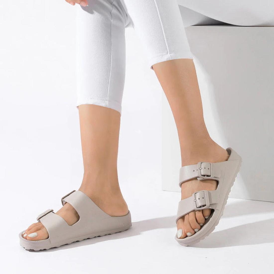 A pair of Beige Holster sundreamer sandals on a woman's feet. Shoing the inner side view of the right foot and the outer side view of the left foo. The model is waering whote 3/4 pants and white nail polish.
9337771179989,
9337771179996,
9337771180008,
93