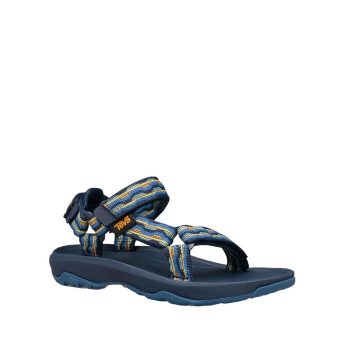 The Teva Kids K Hurricane XLT2 Kishi Dark Blue is a hiking sandal with multicolored recycled straps, a thick textured sole, hook-and-loop closure, and branded tag.