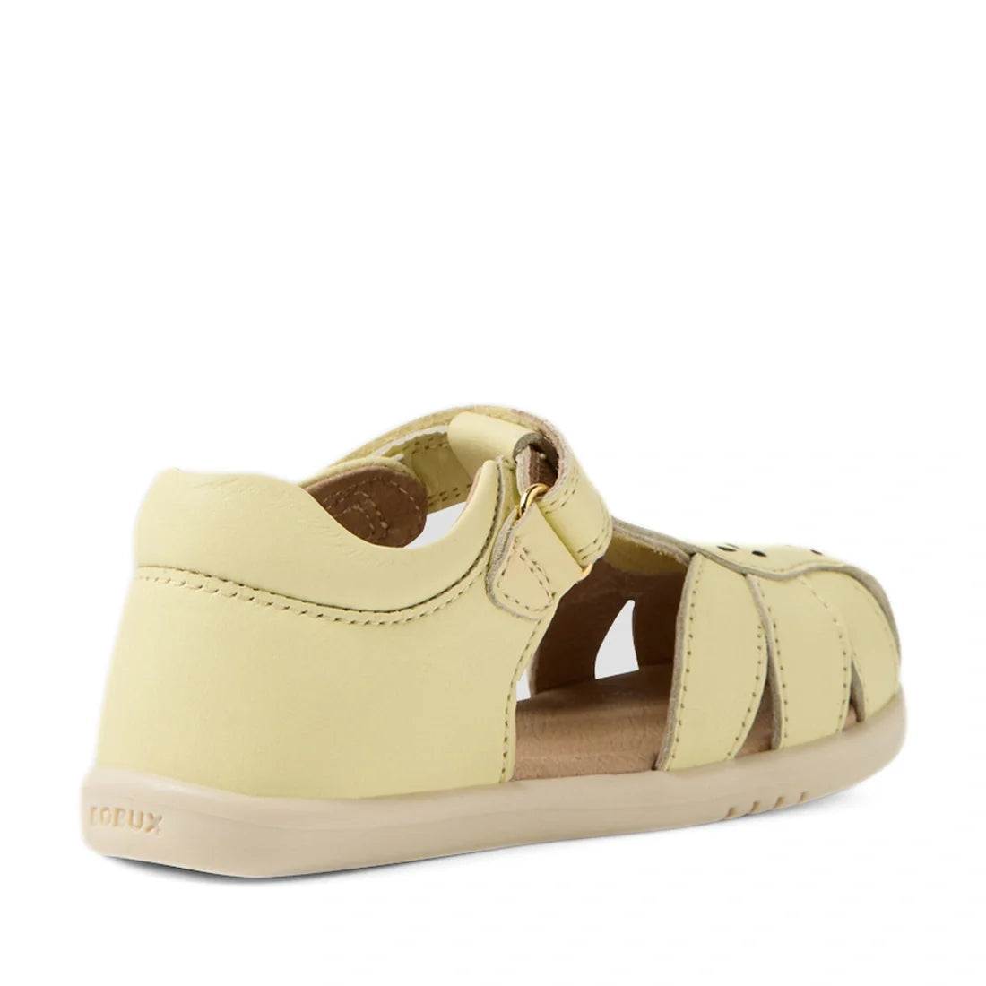 The Bobux IWalk Holly Toddlers Sandal in Wax Yellow, featuring a closed toe, closed heel, Velcro strap, open sides, and quick-drying leather construction, is displayed from a rear side angle on a white background., 9420074852892, 9420074852908, 9420074852