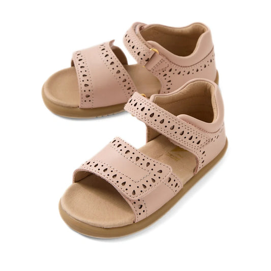 A pair of Bobux IWalk Logan Toddlers Sandal in Cameo Rose Pink, featuring open toes, perforated patterns, and Velcro straps. These tan-colored leather sandals include a soft cushioned footbed for added comfort.