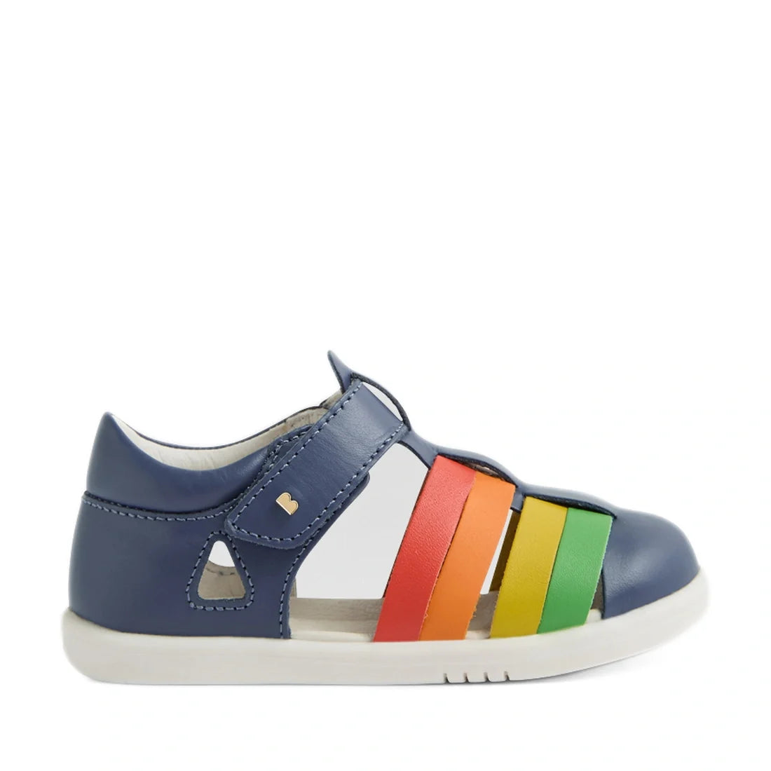 A side view of the Bobux IWalk Tidal Sandal in Multi Vintage Indigo for toddlers, featuring a blue water-friendly leather upper, a white sole, and vibrant straps in red, orange, yellow, and green. These closed-toe sandals are designed to protect little fe