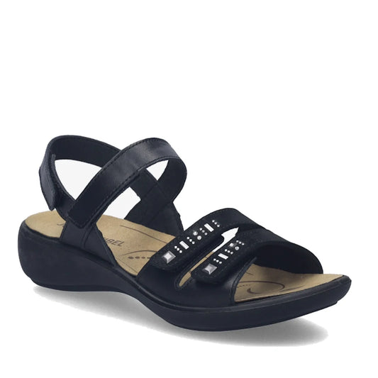 The Josef Seibel Ibiza 86 Womens Leather Comfort Sandal in Schwarz Black is a stylish black open-toe sandal featuring a low heel, two adjustable front straps embellished with decorative studs, and a cushioned beige insole for all-day comfort—an ideal choi