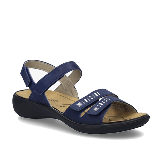 Step into comfort and style with the Josef Seibel Ibiza 86 Women’s Leather Comfort Sandal in Ocean Blue. These sandals feature an open-toe design, two front straps embellished with silver studs, and a convenient velcro ankle strap. A low black heel and li
