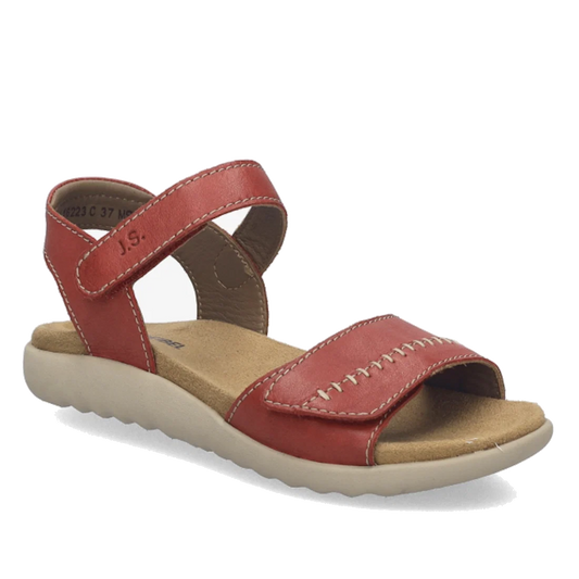 A single Josef Seibel Juliet 03 Womens Leather Comfort Sandal is shown in red leather with a beige sole, featuring a Velcro ankle strap and visible white stitching. This women’s sandal has an open toe and heel design, and is displayed on a plain white bac