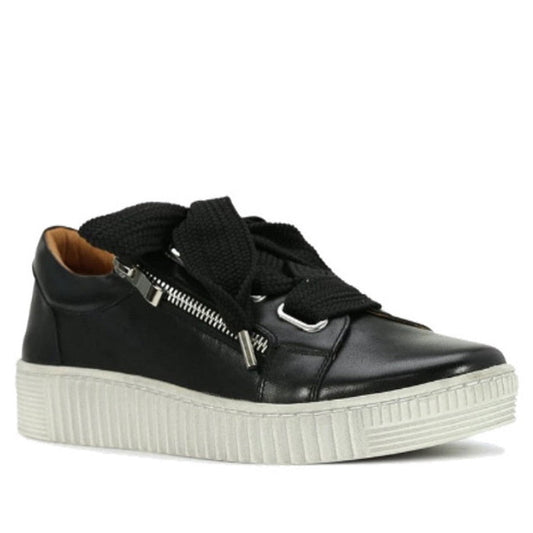 The EOS Jovi Leather Trainer features black Italian leather, thick black laces, a silver side zipper, tan inner lining, and a chunky rubber sole. The shoe is shown angled to display both its side and front.