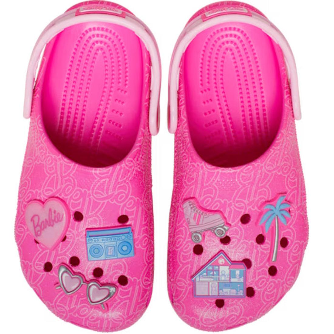 Top down view of a pair of pink barbie children's clogs with cartoon designs  and jibbitz on a white background,
198445228865,
198445228872,
198445228889,
198445228896,
198445228902,
198445228919,, 45955, 45956, 45957, 45958, 45959, 198445228865, 19844522