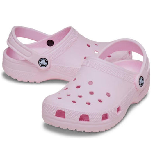 A pair of Toddlers Crocs Soft Pink clogs sandals with a white sole on a white background