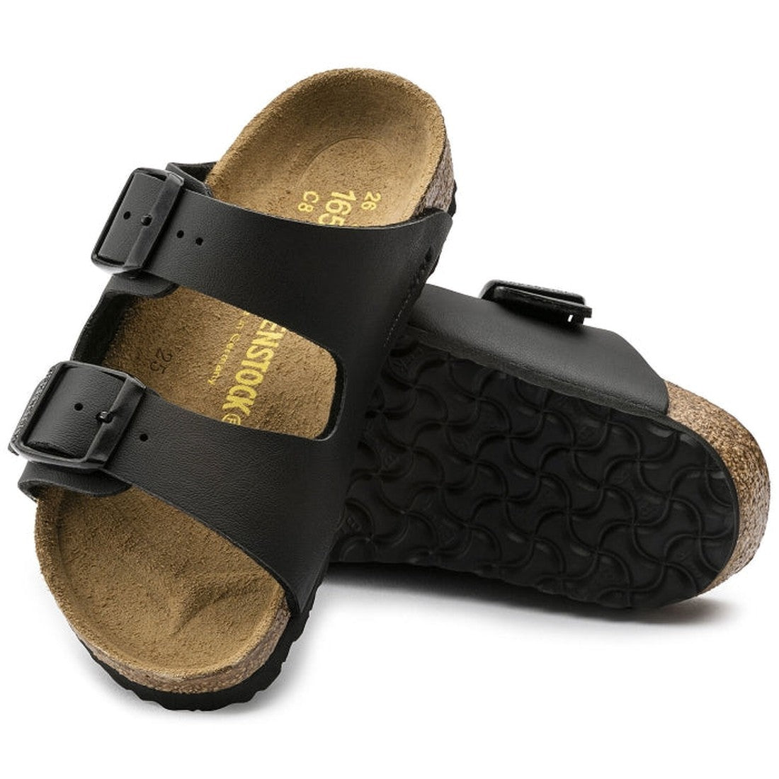 a pair of Birkenstock Kids Black Arizona Sandal Narrow Width Birko Flor with double straps, one over the foot and one over the toes with buckle adjustment. Staps are linked at the sides of the foot. Synthetic straps and a suede leather footbed,