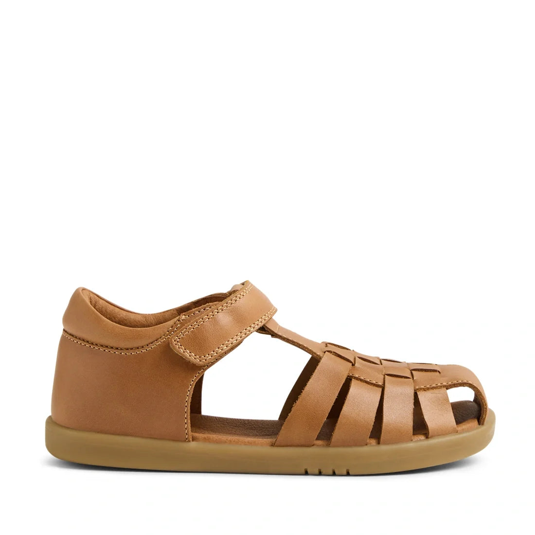 Introducing the Bobux Kid+ Plus KP Harbor Caramel Closed Toe Sandal, a children’s sandal made from water-friendly caramel brown leather. This style features a closed heel, an open toe, an adjustable velcro strap, and a unique woven design for both functio