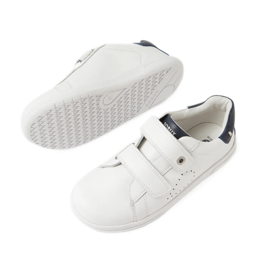 The Bobux IW Iwalk Maverick Toddlers Leather Sneaker in White Navy is a sporty kids’ shoe crafted from white leather with Velcro adjustable straps and navy blue accents, displayed from the side and bottom views against a white background., 9420074857408, 
