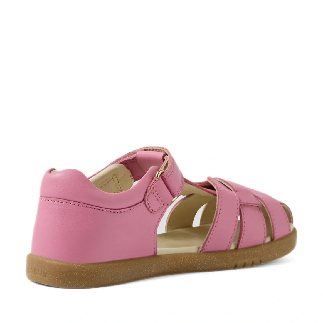 The Bobux Kids Plus KP Skip Twist Cashmere Rose Pink Closed Toe Sandal is a toddler summer shoe featuring a closed toe, closed heel, open sides, and Velcro strap on a light brown rubber sole, shown from the back left angle., 9420074848390, 9420074848406, 