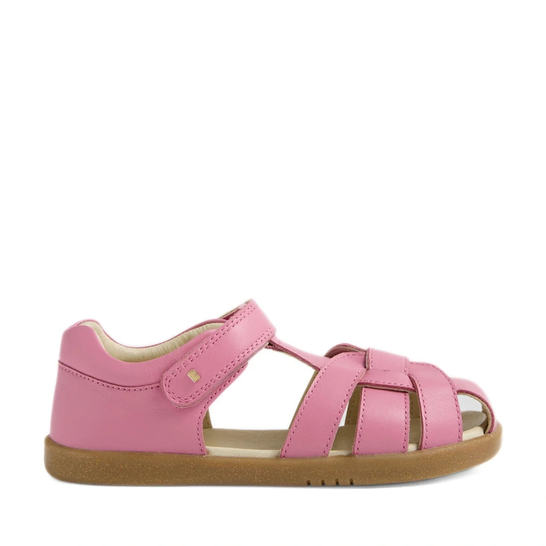 Introducing the Bobux Kids Plus KP Skip Twist Cashmere Rose Pink Closed Toe Sandal—a stylish pink leather sandal designed for children, featuring a closed heel, open toe, and intricately woven leather straps. Perfect for summer adventures, this kids’ sand