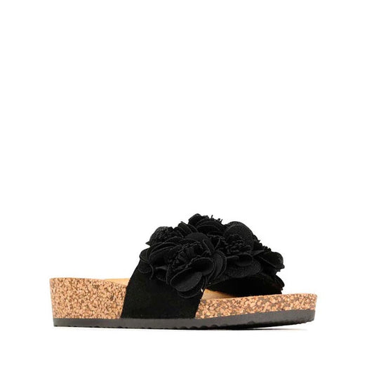 The Los Cabos Corsage Black Flower Women's Slides feature a cork sole, open toe, and wide strap with layered floral embellishments, combining casual style and comfort for everyday wear.