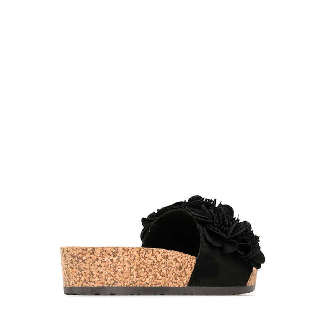 The Los Cabos Corsage Black Flower Women's Slides feature a black slip-on design with a thick cork wedge heel and floral accents on the upper, displayed from the side against a white background., 9321191212517, 9321191212524, 9321191212531, 9321191212548,