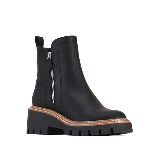 The Los Cabos Vianne Women's Chelsea Zip Black Boot PU features a black ankle design, chunky sole, brown stitching above the sole, silver side double zips, and a back pull tab—shown against a white background.