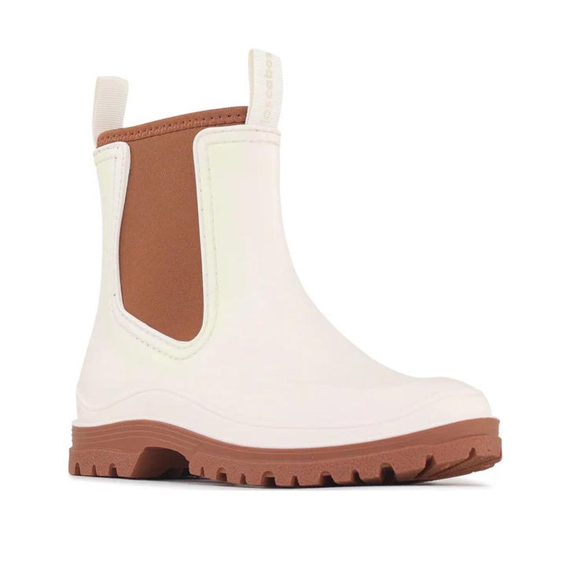 The Los Cabos Amelia Cream Ankle Rain Boot Waterproof features an off-white upper, chunky brown sole, brown elastic side panel, neoprene lining, pull tab at the back, and a sleek minimalist design.