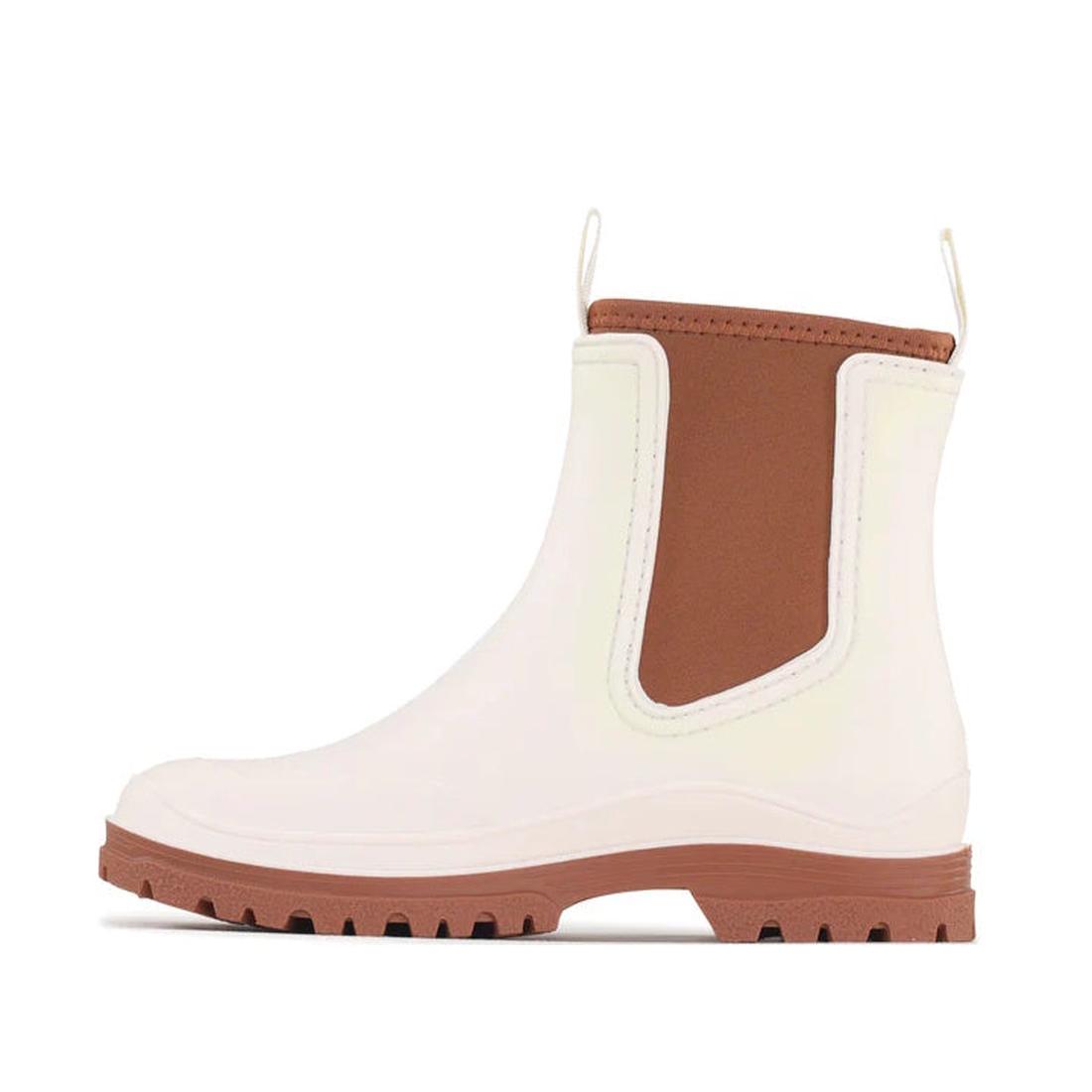 The Los Cabos Amelia Cream Ankle Rain Boot Waterproof features brown elastic side panels, a brown pull tab, treaded sole, and practical neoprene lining for style and comfort. Shown in profile against a plain background., 9321190004977, 9321190004984, 9321