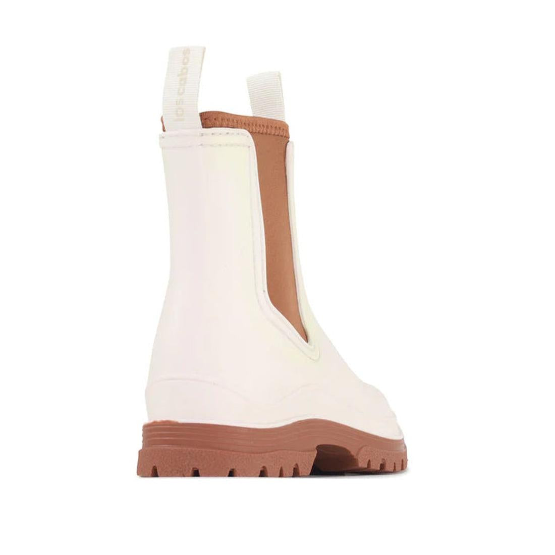 The Los Cabos Amelia Cream Ankle Rain Boot Waterproof is shown from a back side angle, featuring a chunky brown sole, tan side panels, and front and back pull tabs against a white background., 9321190004977, 9321190004984, 9321190004991, 9321190005004, 93