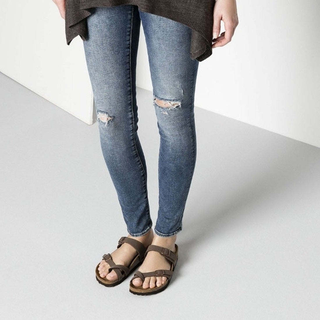 a modal wearing a pair of Birkenstock Mayari sandals in mocca brown showing the buckle adjustment across the top of the foot and over the toes.,
4040714632537,4040714632520,4040714632544,4040714632551,4040714632568,4040714632575,4040714632582, , , , , , 

