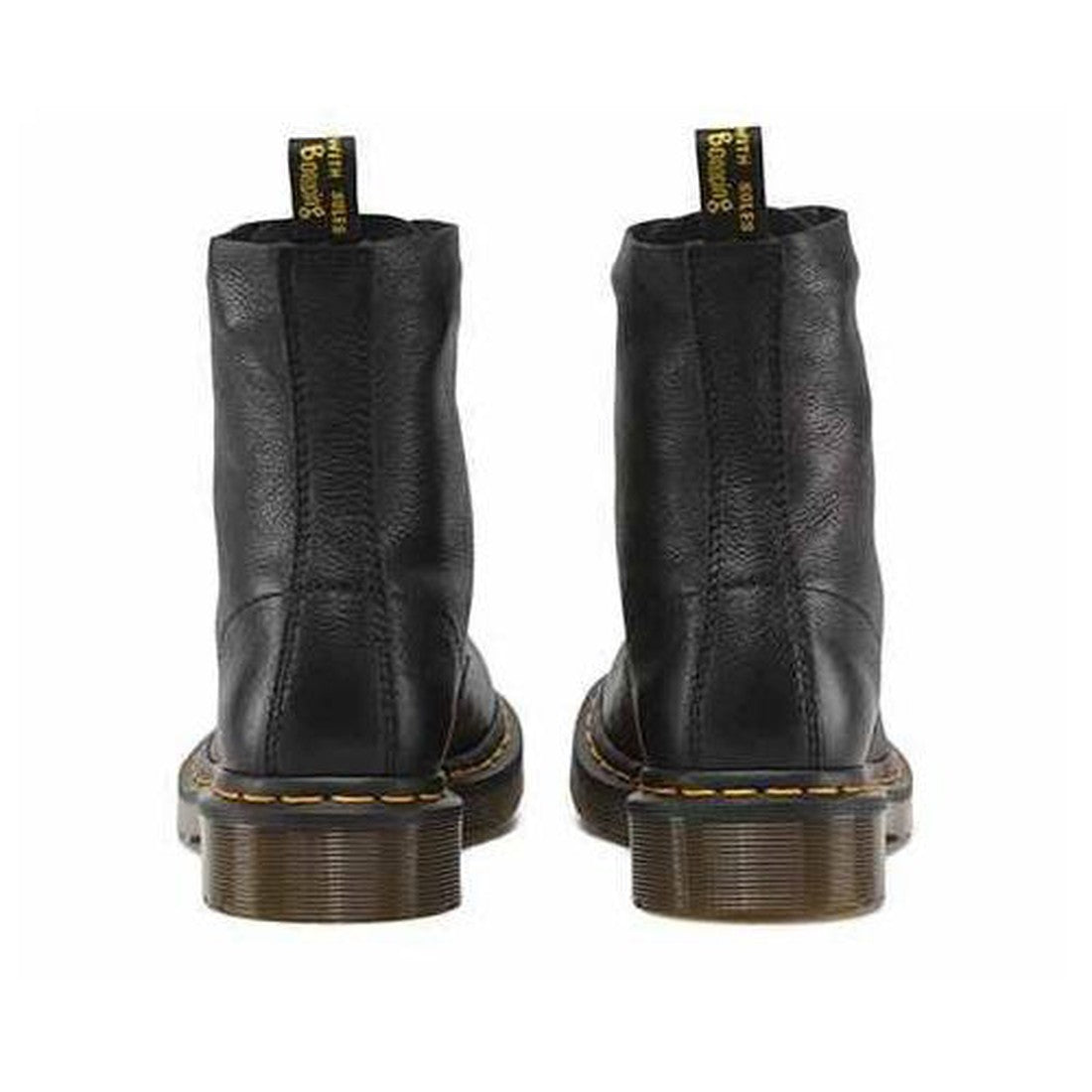 the rear heel view of Dr Martens 1460 Pascal in virginia leather showing the black leather, stitching of the re-enforcing up the heel pull tab straps, cut off leather at the top of the leg (no binding) and brown heel with yellow stitching around the sole.