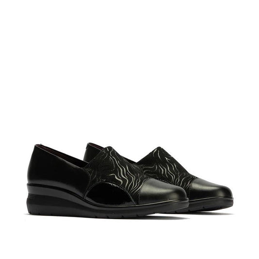 The Pitillos Womens Lycra and Patent Leather Shoe 10731 features black uppers with subtle wave patterns, glossy patent leather toe caps and heels, a removable insole, and wedge soles, shown against a white background.