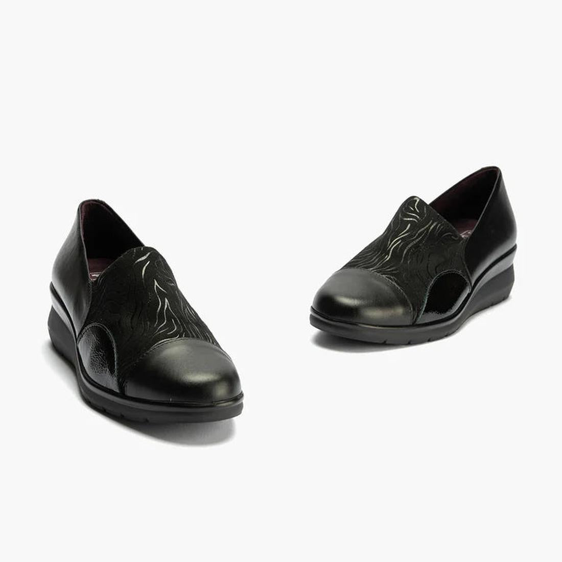 The Pitillos Womens Lycra and Patent Leather Shoe 10731 features a black wedge design with subtle curved patterns, removable insole, and low heels, displayed against a light background., 8445191655554, 8445191655561, 8445191655578, 8445191655585, 51923, 5