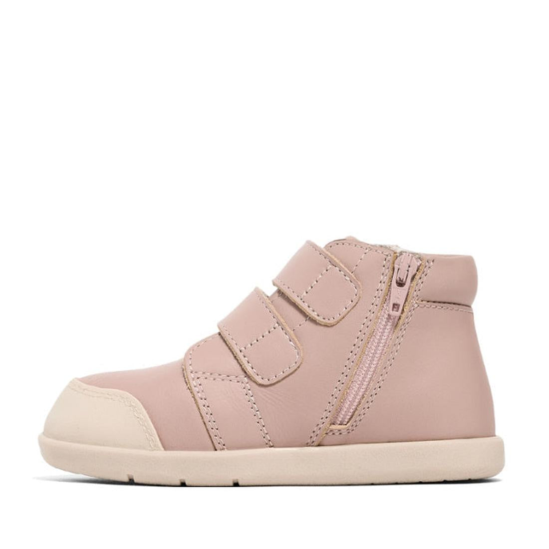 The Pretty Braver Blake Leather Boot First Walker Blush is a light pink hi-top toddler shoe with a cream sole, two velcro straps, side zipper, and reinforced toe cap; APMA-approved and shown in profile on a white background., 9400275329195, 9420075329188,