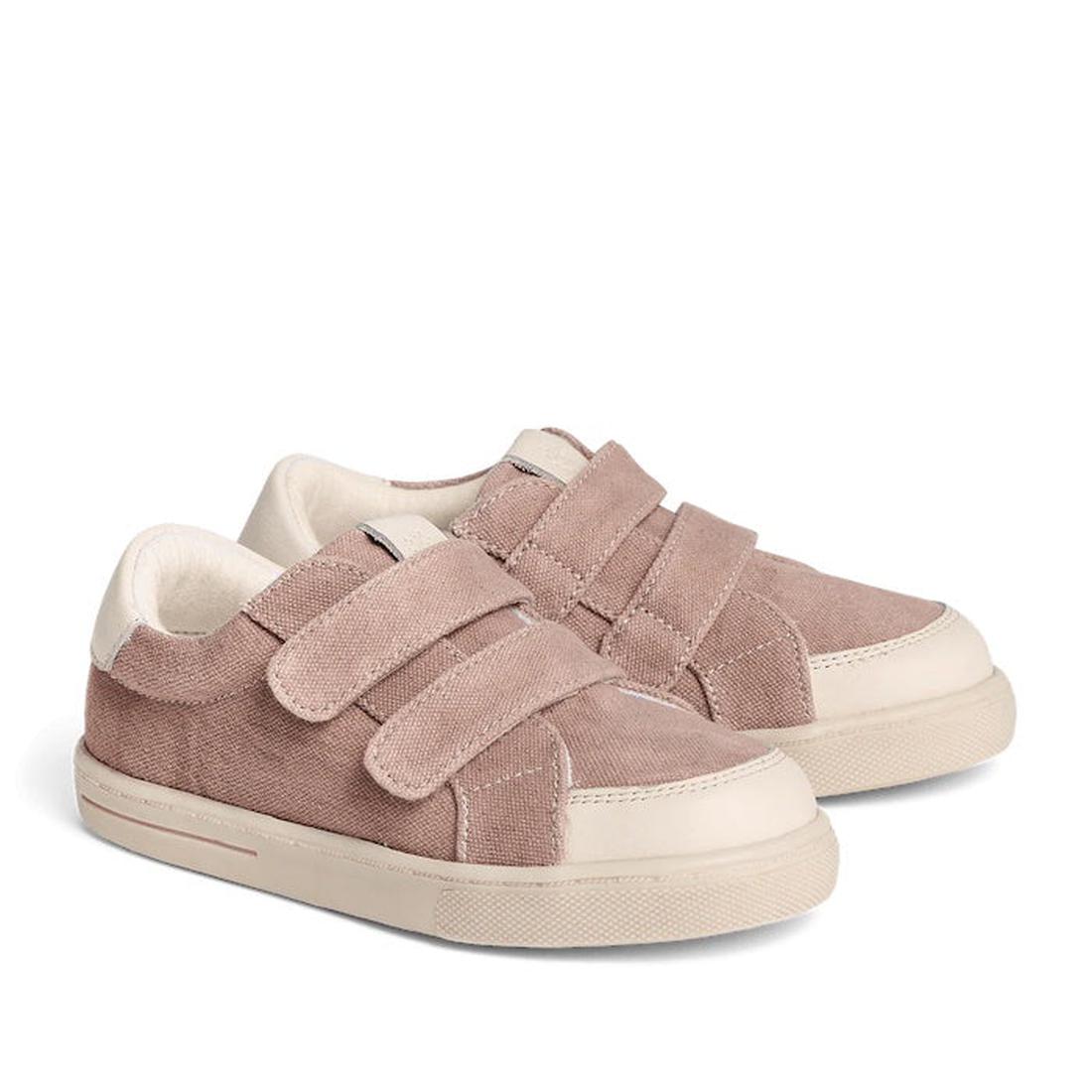 The Pretty Brave Otto Organic Canvas Trainer in pink features a leather toe buffer, white soles, and two velcro straps per shoe, crafted from organic canvas, displayed on a white background.
