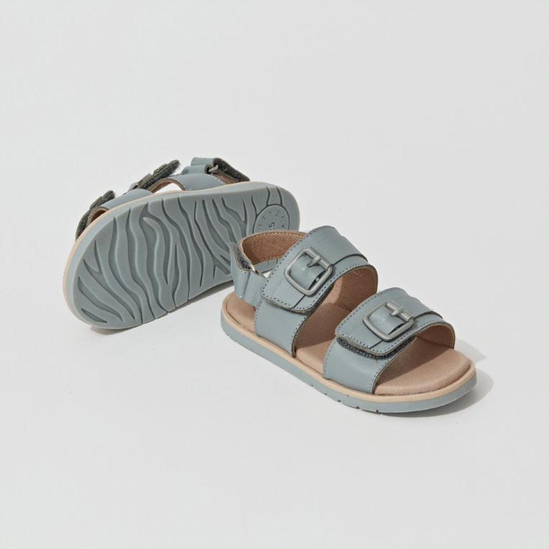 Pretty Brave Alex Leather Sandal Seaform Blue (sizes 29-33, CLEARANCE, NOT RETURNABLE) for kids features two adjustable buckle straps and textured rubber soles; one sandal is upright, the other shows the sole pattern., 9421036357684, 9421036357691, 942103