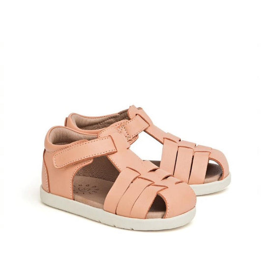 Pretty Braver Billie First Walker Sandal Closed Back Coral: toddler sandals in light pink with closed heels, open toes, adjustable Velcro straps, woven front design, white rubber soles. Lightweight and flexible—ideal for early walkers.