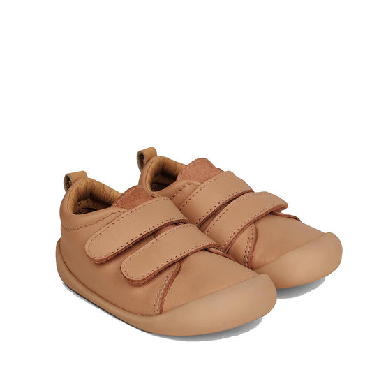 The Pretty Brave First Walker Toto Leather Trainer Tan features two Velcro straps, rounded toes, and soft leather—ideal toddler sneakers for comfort and easy fastening as little ones take their first steps.