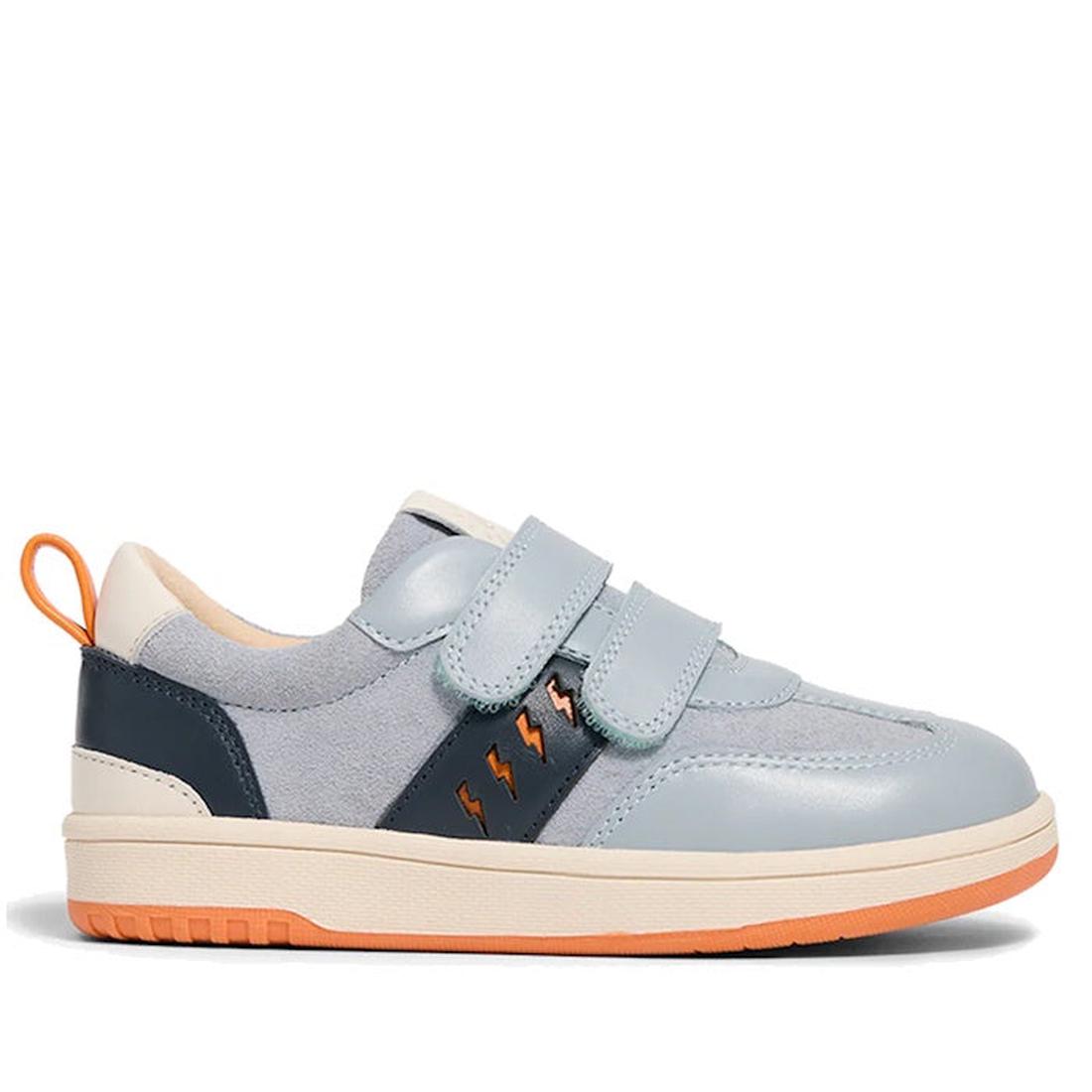 The Pretty Brave River Bolts Leather Trainer Blue Grey is a sporty kids' shoe with blue and navy tones, orange accents, lightning bolt details, dual velcro straps, white sole, and orange heel tab—podiatrist approved for active growing feet.