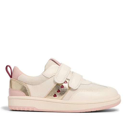 The Pretty Brave River Hearts Leather Trainer in Pink Off White is a kids' sporty sneaker with pink and gold accents, two Velcro straps, a red heel pull tab, and small red heart-shaped cutouts on the side.