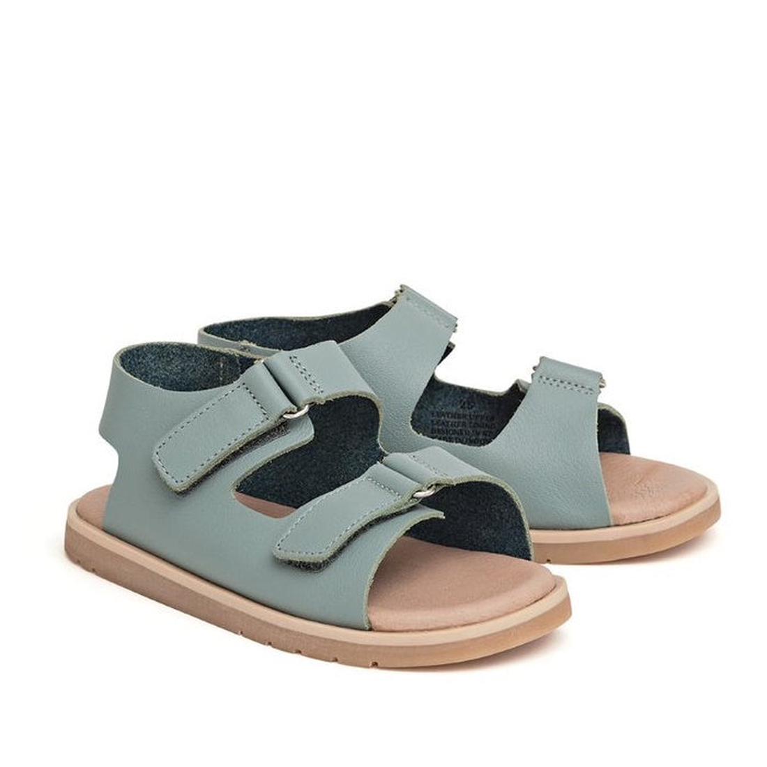 A pair of Pretty Brave Wilder Seafoam Blue Kids Sandals (sizes 29-31), featuring two adjustable Velcro straps and a flat tan sole with a lightweight TPR outsole. CLEARANCE—NOT RETURNABLE.