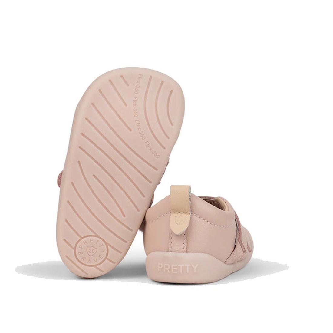 The image shows two Pretty Brave First Walker Toto Leather Trainers in Dusky Pink for toddlers: one upright and one on its side, revealing "PRETTY" near the heel and a sole with wavy grip lines and a circular logo., 9420075366329, 9420075366312, 942007536