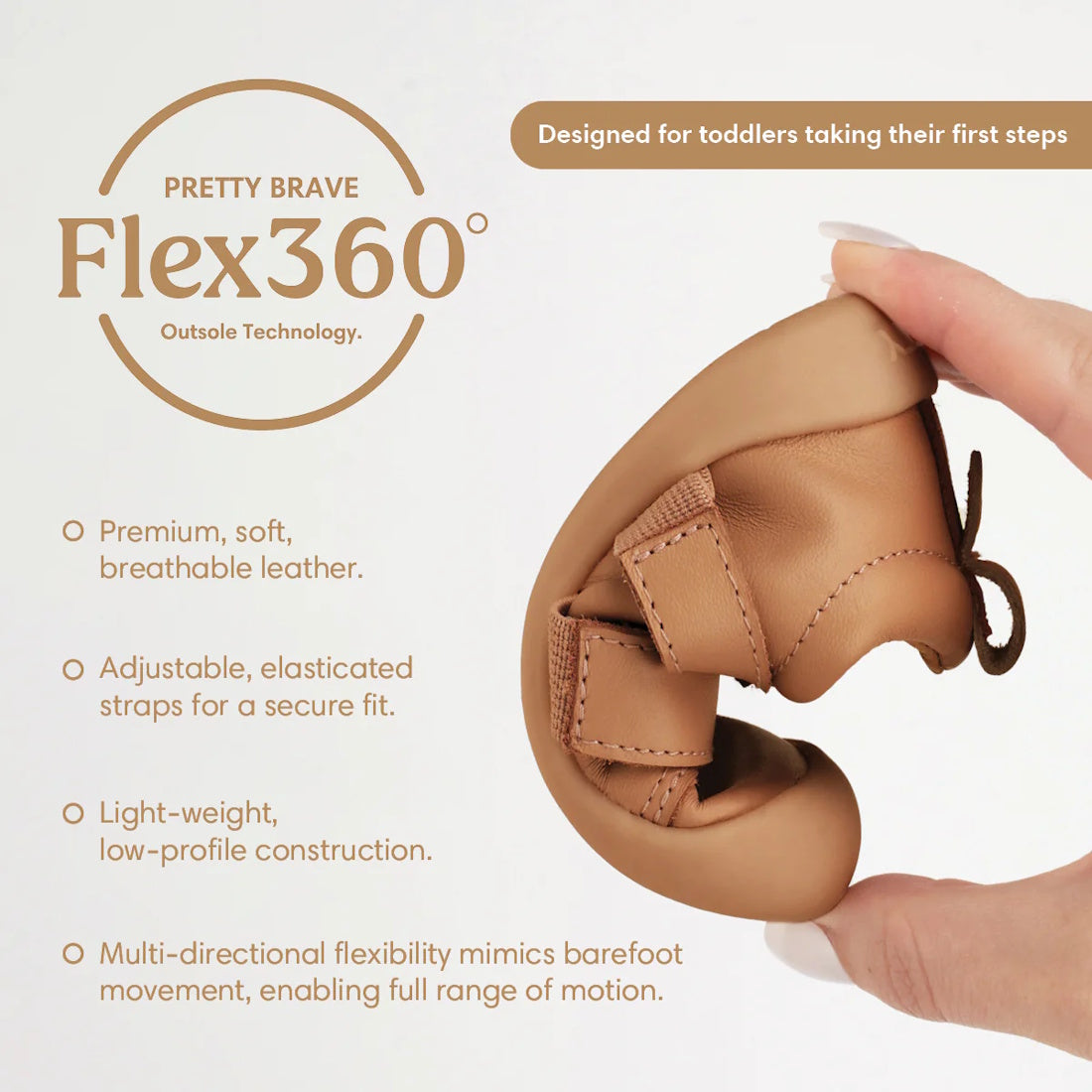 A hand bends the Pretty Brave First Walker Toto Leather Trainer Tan to show its flexibility. Features include breathable leather, adjustable straps, lightweight design, and multi-directional flexibility for first steps., 9420075366183, 9420075366176, 9420
