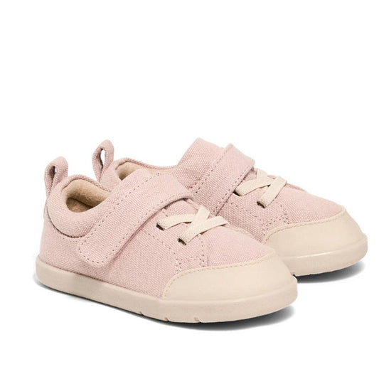 The Pretty Brave Boston CANVAS Trainer First Walker in Blush Pink features light pink organic cotton canvas, cream soles, beige toe caps, elastic laces, and hook-and-loop straps, shown side by side on a plain white background.