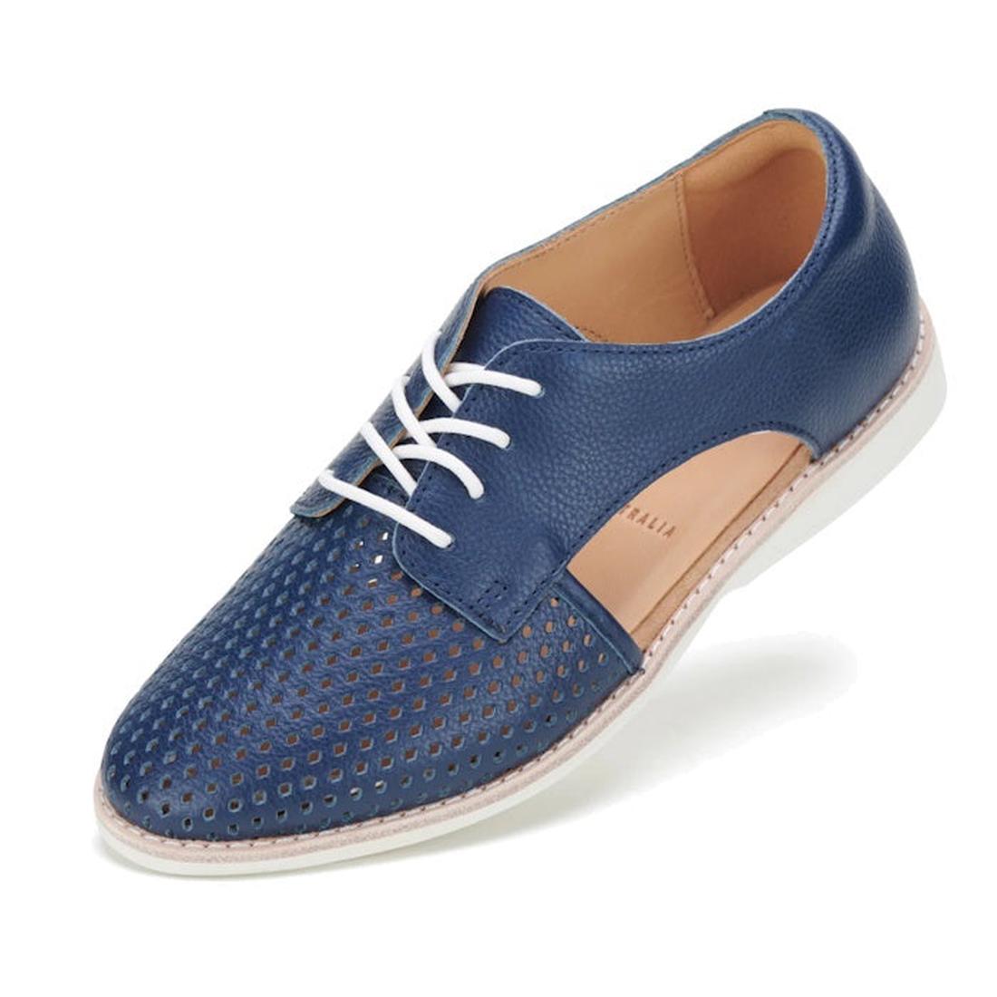 The Rollie Womens Sidecut Punch Navy Tumble Leather Shoe features blue leather with punch hole detailing, white laces, tan interior, breathable linings, cut-out sides, and a white anti-slip rubber outsole.