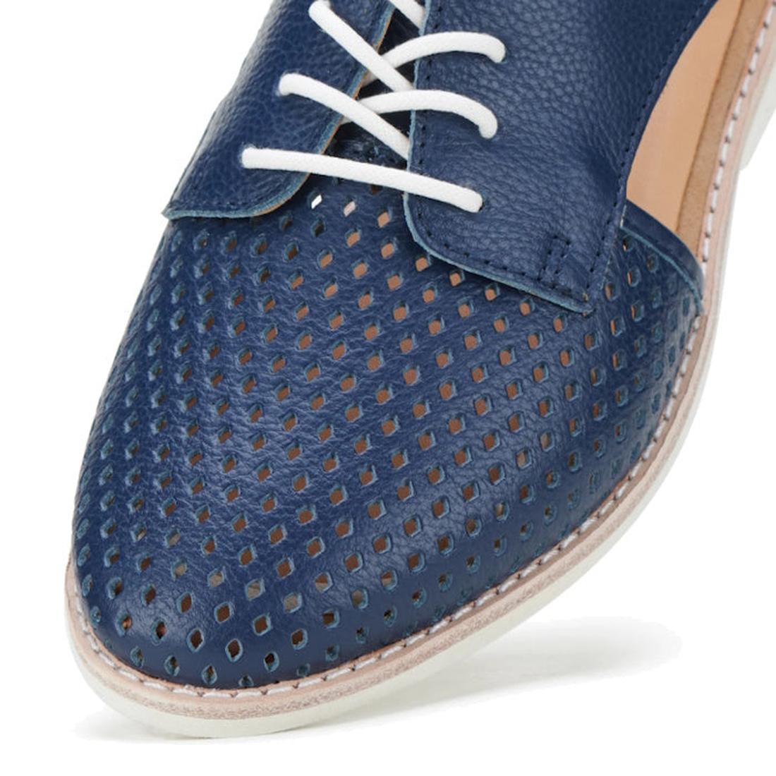 Close-up of the toe and upper of the Rollie Womens Sidecut Punch Navy Tumble Leather Shoe, featuring white laces, punch hole details on the front, a textured navy leather finish, and a light-colored stitched sole for comfort and style., 9781760775414, 978