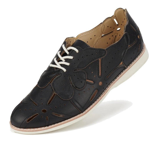 The Rollie Derby Applique Black Womens Leather Brogue Shoe features soft black leather uppers, decorative cutouts, a flower-shaped appliqué, white laces, and a white rubber sole—an Australian-designed classic.