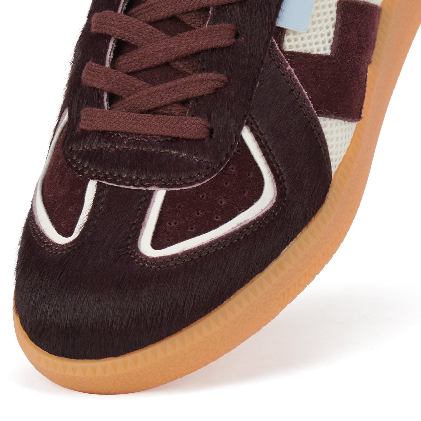 Close-up of the Rollie Womens Pace Dark Cherry Bone Suede Sneaker's toe box, showcasing dark cherry suede, pony hair, white trim, light blue accent panel, mesh side panel, and a translucent gum outsole in a minimalist style., 9339554000315, 9339554000317,