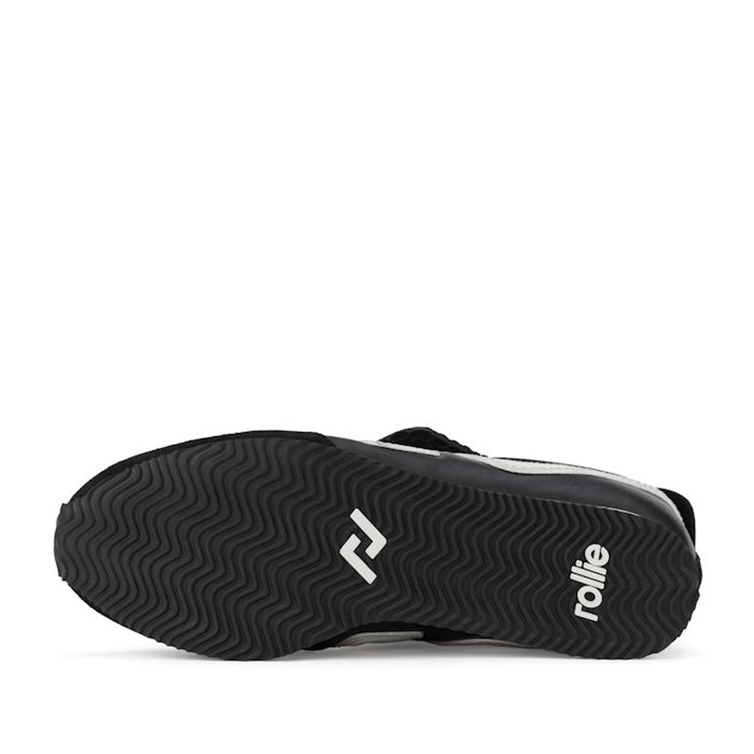 The image shows the black rubber sole of the Rollie Womens Shift Black/Bone Sneaker, model PS00093, featuring the rollie logo and a geometric white design with a wavy tread pattern for grip., 9339554369945, 9339554362427, 9339554100234, 9339554006246, 933