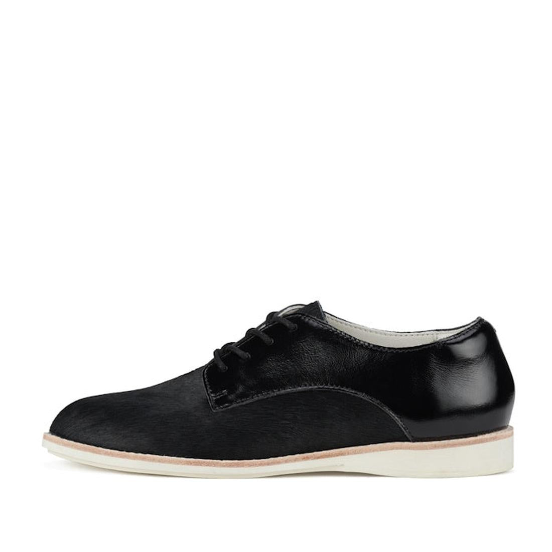 The Rollie Womens Derby Black Splice Leather Brogue Shoe is a black leather oxford with a white sole, black laces, and polished finish, featuring an orthotic-friendly removable footbed, shown in a side view on a white background., 51190, 9339554014920, 93