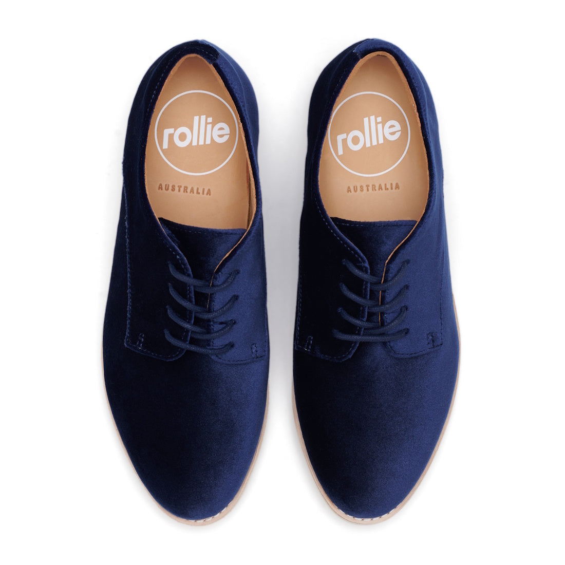 The Rollie Womens Derby Navy Velvet Brouge Shoe, style SC02100, features navy velvet lace-up design and tan insoles with the rollie logo and AUSTRALIA text, shown from above on a white background., 9339554000046, 9339554035741, 9339554028743, 933955400612