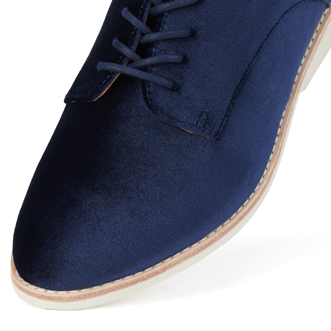Close-up of the front part of the Rollie Womens Derby Navy Velvet Brogue Shoe, showcasing light stitching, a beige sole, and lace-up design., 9339554000046, 9339554035741, 9339554028743, 9339554006123, 9339554009810